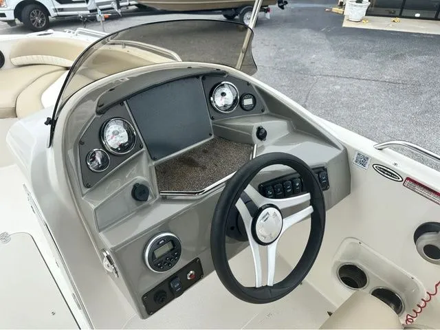 Slide: The Image of Dashboard of a 2016 Stingray 192 SC boat with steering wheel and gauges. - 6