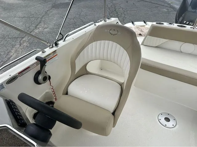 Slide: The Image of Interior of a 2016 Stingray 192 SC boat with steering wheel and seat. - 7