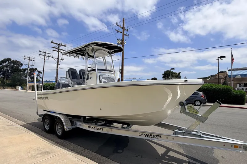 Slide: The Image of 2026 Defiance Catalina 210 boat on trailer, parked on street under blue sky. - 18