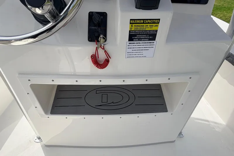 Slide: The Image of 2026 Defiance Catalina 210 boat console with steering wheel and capacity label. - 33