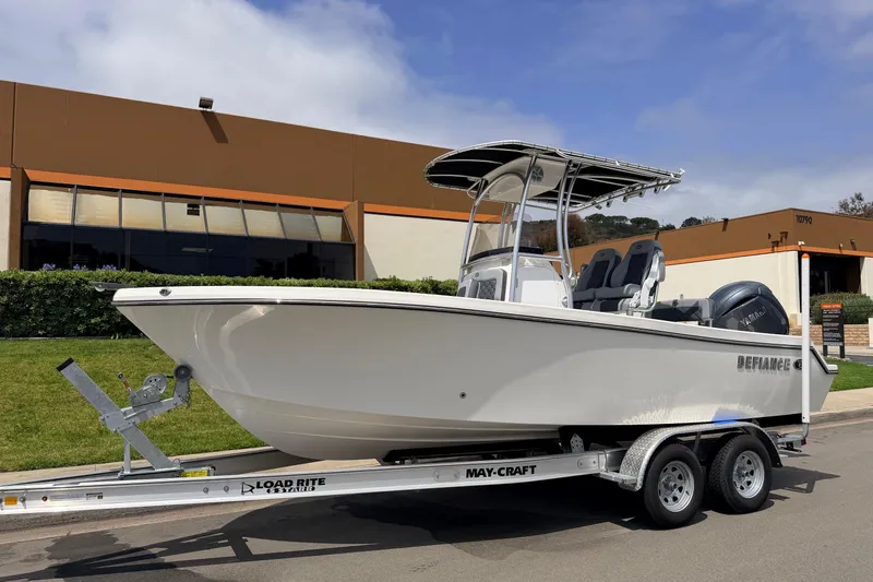 Slide: The Image of 2026 Defiance Catalina 210 boat on trailer, parked outdoors near a commercial building. - 4