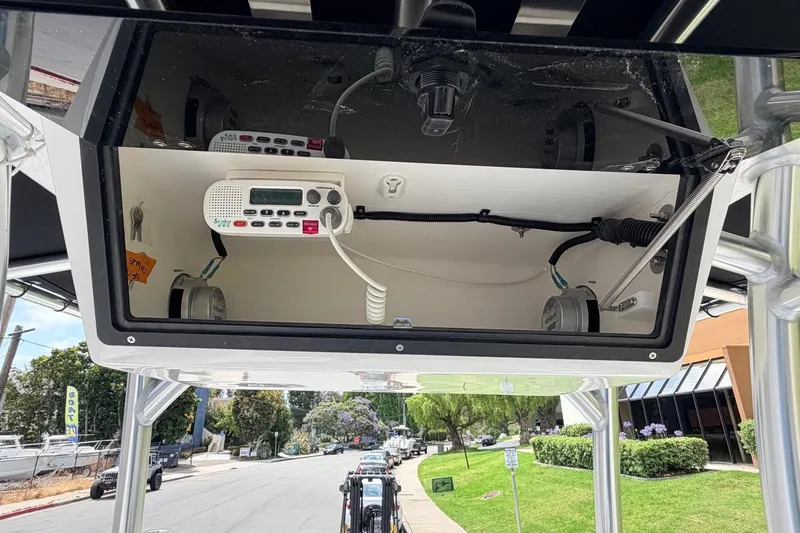 Slide: The Image of 2026 Defiance Catalina 210 boat electronics compartment with radio and wiring. - 40