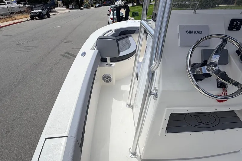 Slide: The Image of 2026 Defiance Catalina 210 boat interior with steering wheel and Simrad navigation system. - 41