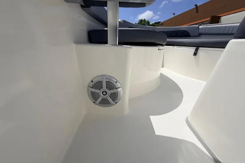 Slide: The Image of Interior view of 2026 Defiance Catalina 210 boat, featuring seating and speaker system. - 45