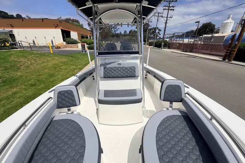 Slide: The Image of 2026 Defiance Catalina 210 boat interior with gray seating and open deck design. - 47