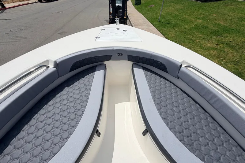 Slide: The Image of 2026 Defiance Catalina 210 boat interior with gray cushioned seating and hexagonal pattern design. - 49