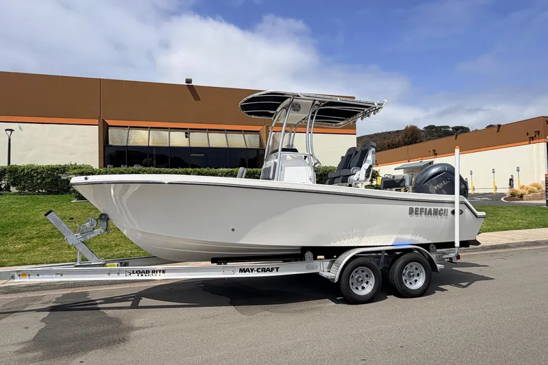 Slide: The Image of 2026 Defiance Catalina 210 boat on trailer, parked outdoors near industrial building. - 5