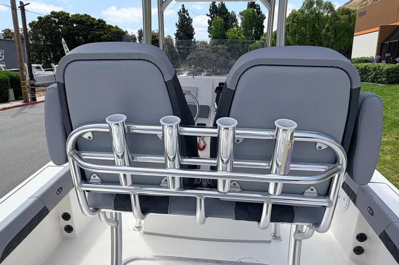Slide: The Image of 2026 Defiance Catalina 210 boat seats with rod holders, parked outdoors. - 59