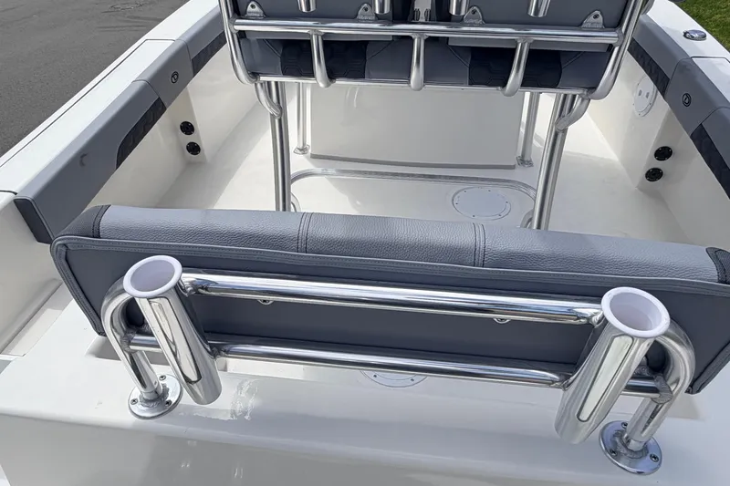 Slide: The Image of 2026 Defiance Catalina 210 boat interior with cushioned seating and stainless steel rod holders. - 60