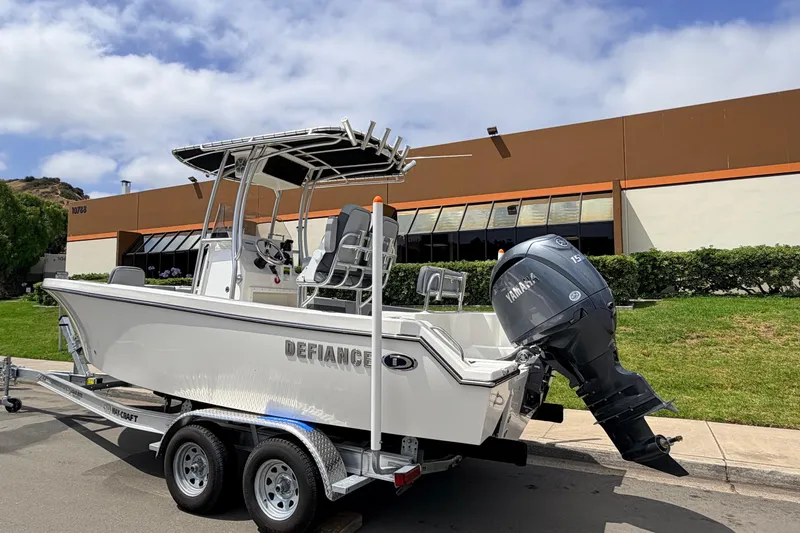 Slide: The Image of 2026 Defiance Catalina 210 boat on trailer, parked outdoors with Yamaha outboard motor. - 8