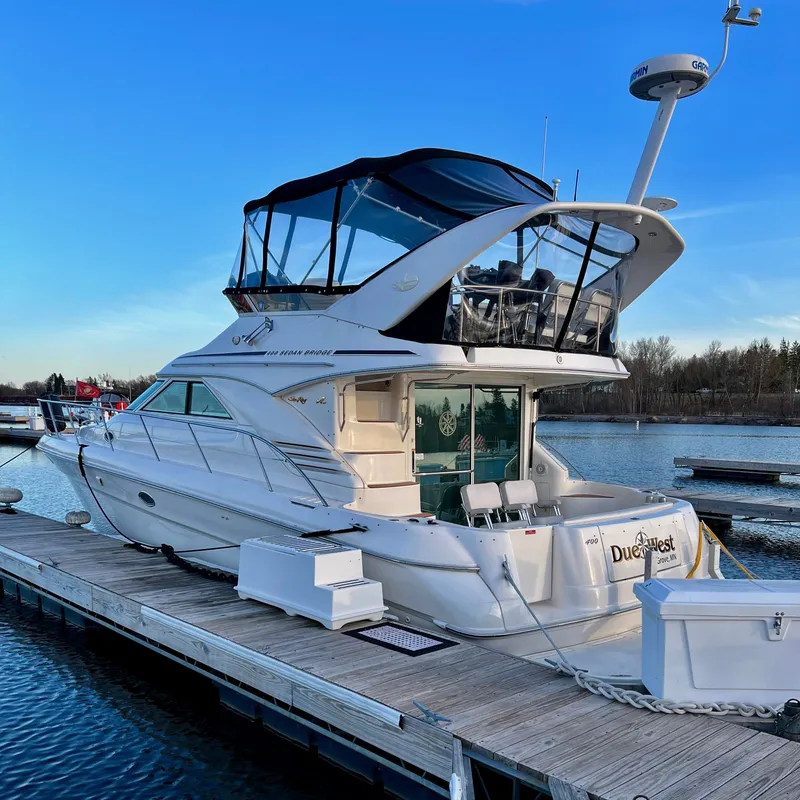The Image of 1996 Sea Ray 400 Sedan Bridge docked at sunset. - 0