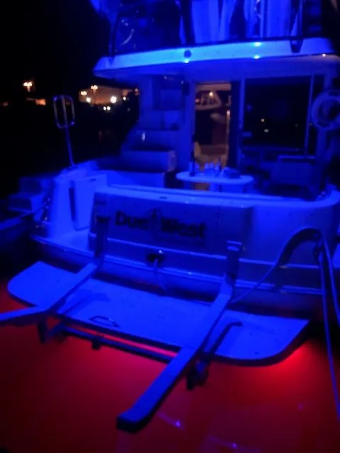 Slide: The Image of 1996 Sea Ray 400 Sedan Bridge at night with blue lighting. - 4