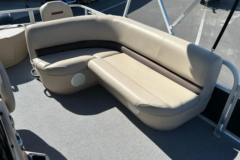 Slide: The Image of 2017 Sun Tracker Bass Buggy 18 DLX pontoon boat with beige seating and spacious deck. - 11