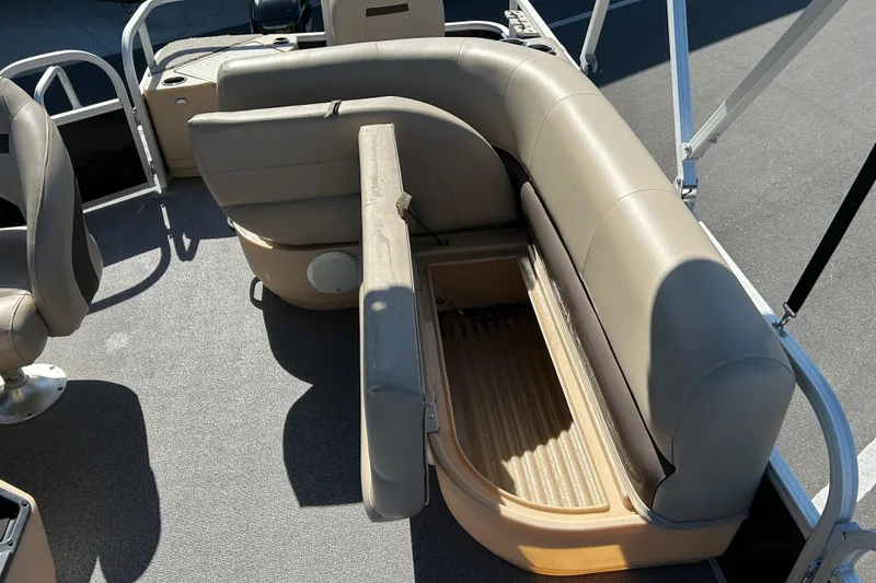 Slide: The Image of 2017 Sun Tracker Bass Buggy 18 DLX pontoon boat interior with open storage compartment. - 14