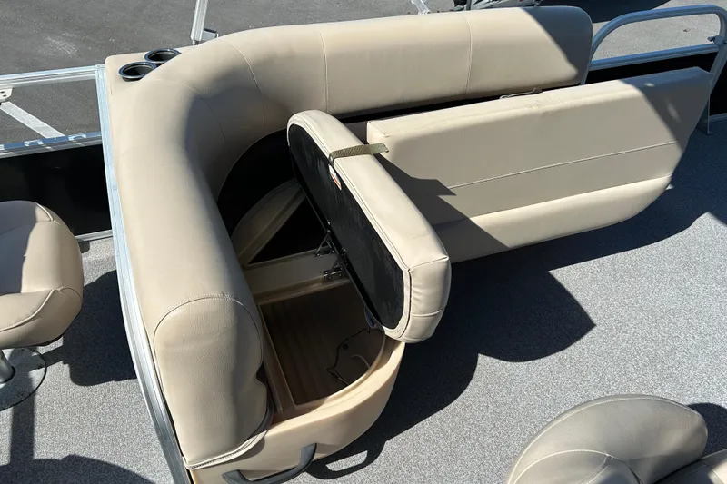 Slide: The Image of 2017 Sun Tracker Bass Buggy 18 DLX boat interior with beige seating and storage compartment. - 15