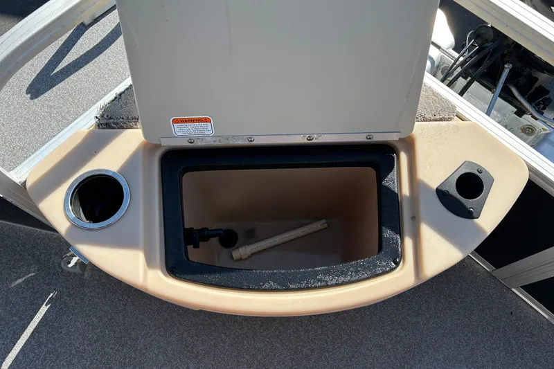Slide: The Image of 2017 Sun Tracker Bass Buggy 18 DLX boat storage compartment with cup holders. - 17