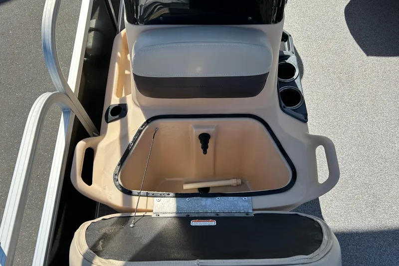 Slide: The Image of 2017 Sun Tracker Bass Buggy 18 DLX boat interior with storage compartment and seating. - 18