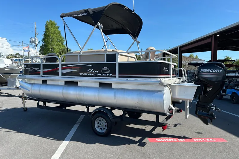 Slide: The Image of 2017 Sun Tracker Bass Buggy 18 DLX pontoon boat with Mercury outboard motor on trailer. - 4