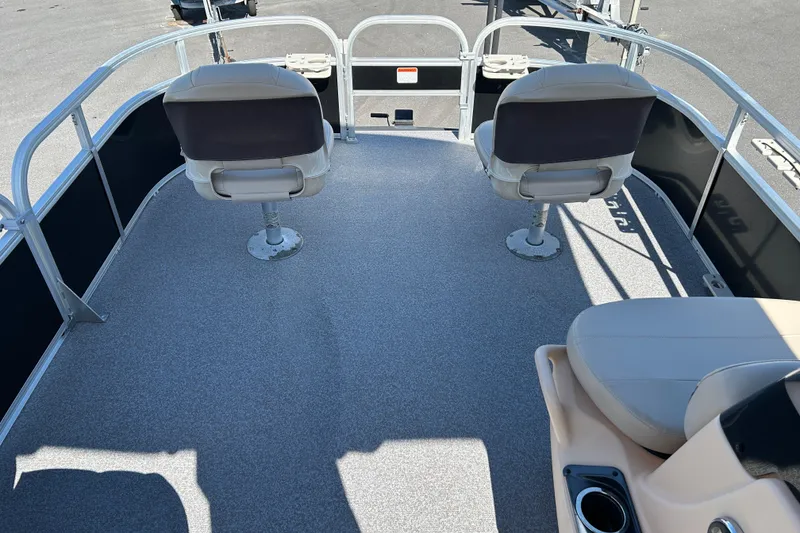 Slide: The Image of 2017 Sun Tracker Bass Buggy 18 DLX pontoon boat interior with seating and railing. - 8