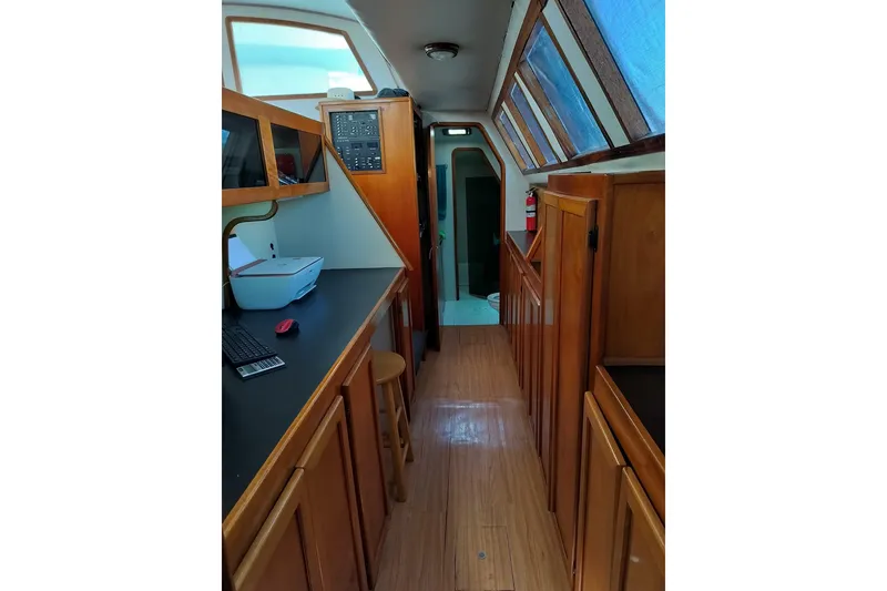 Slide: The Image of Interior of 2003 Custom Leopard Morrelli & Melvin 46 yacht with wooden cabinetry and workspace. - 13