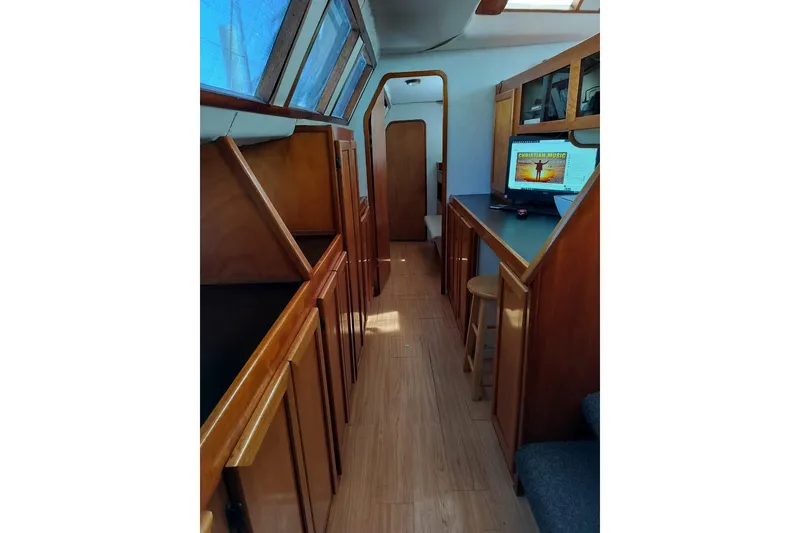 Slide: The Image of Interior of 2003 Custom Leopard Morrelli & Melvin 46 yacht with wooden cabinetry and seating. - 14