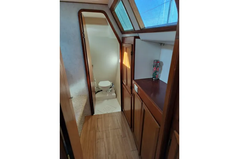 Slide: The Image of Interior of 2003 Custom Leopard Morrelli & Melvin 46 yacht, featuring wooden cabinetry and skylight. - 15