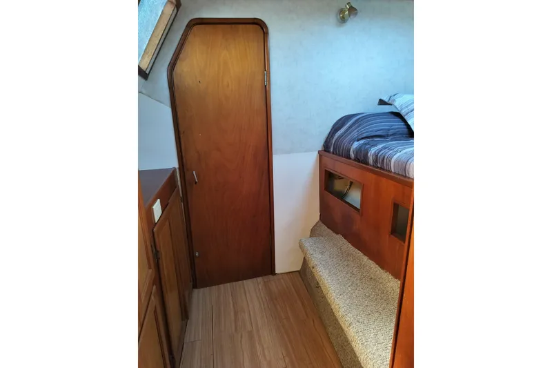 Slide: The Image of Interior of 2003 Custom Leopard Morrelli & Melvin 46 yacht, featuring wooden door and cozy bunk bed. - 17