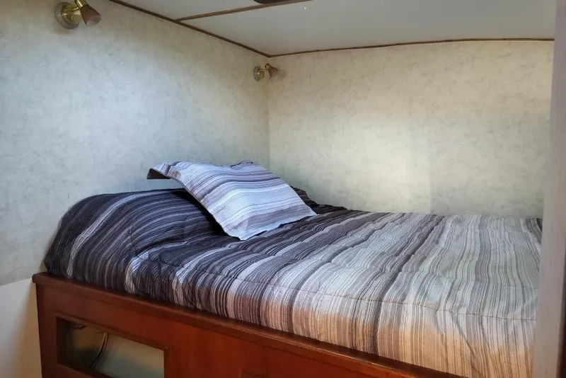 Slide: The Image of Cozy cabin bed with striped bedding in 2003 Custom Leopard Morrelli & Melvin 46 yacht. - 18