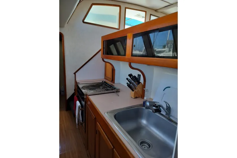 Slide: The Image of Kitchen area of a 2003 Custom Leopard Morrelli & Melvin 46 yacht, featuring a sink and stove. - 19