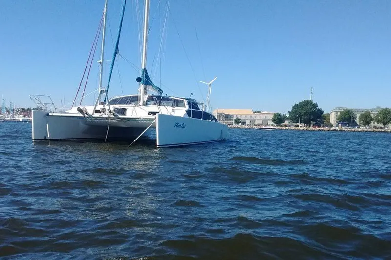 Slide: The Image of Custom Leopard Morrelli & Melvin 46 catamaran, 2003, anchored on calm waters under clear blue sky. - 2