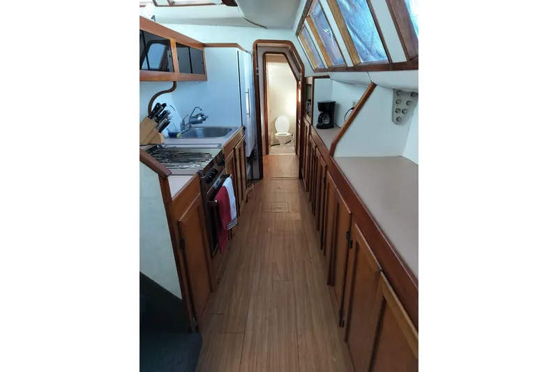 Slide: The Image of Interior of 2003 Custom Leopard Morrelli & Melvin 46 yacht, featuring a compact kitchen area. - 21