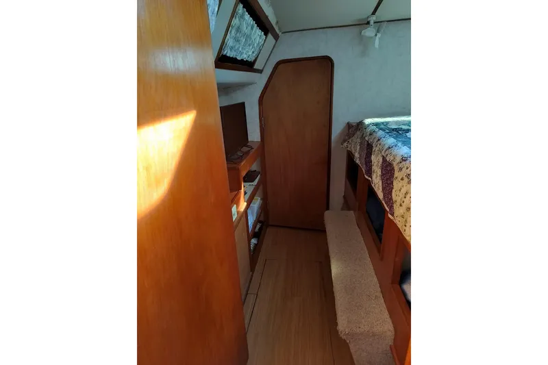 Slide: The Image of Interior of 2003 Custom Leopard Morrelli & Melvin 46 yacht, featuring wood paneling and cozy sleeping area. - 22