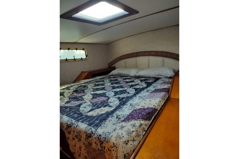 Slide: The Image of Cozy bedroom in 2003 Custom Leopard Morrelli & Melvin 46 yacht with quilted bedding. - 23