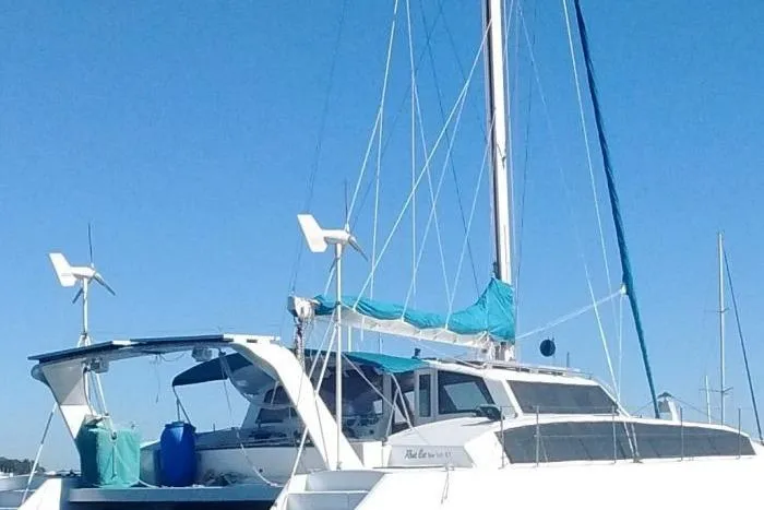 Slide: The Image of Custom Leopard Morrelli & Melvin 46 catamaran, 2003 model, with blue accents, docked under clear skies. - 3