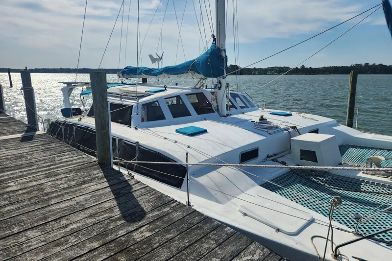 Slide: The Image of Custom Leopard Morrelli & Melvin 46 catamaran docked, 2003 model, with blue accents and netting. - 5