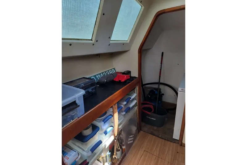 Slide: The Image of Interior of 2003 Custom Leopard Morrelli & Melvin 46 with storage and cleaning supplies. - 9