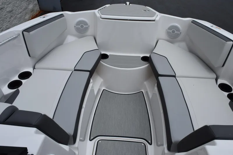 Slide: The Image of 2026 Yamaha Boats AR220 interior with gray seating and cup holders. - 13