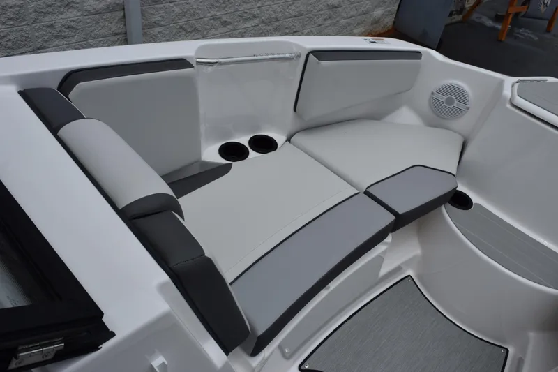 Slide: The Image of 2026 Yamaha Boats AR220 interior seating with cup holders and speaker. - 15