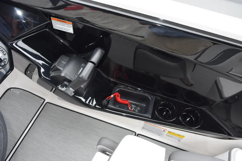 Slide: The Image of Interior view of 2026 Yamaha Boats AR220, featuring control panel and cup holders. - 19
