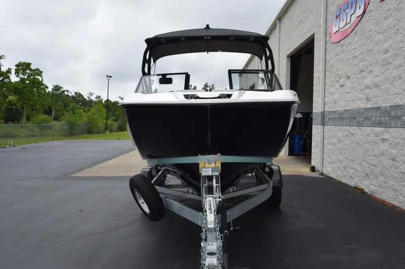 Slide: The Image of 2026 Yamaha Boats AR220 on trailer outside a building, ready for transport. - 3
