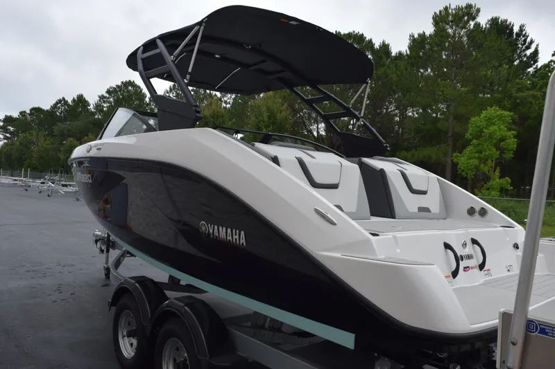 Slide: The Image of 2026 Yamaha Boats AR220 on trailer, sleek design, black and white color scheme, outdoor setting. - 6