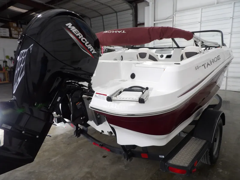 Slide: The Image of 2022 Tahoe 185 boat with Mercury outboard motor in warehouse. - 5