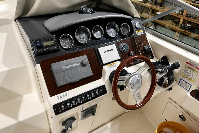 Slide: The Image of 2012 Sea Ray Sundancer 310 helm with Raymarine navigation and Mercury controls. - 10