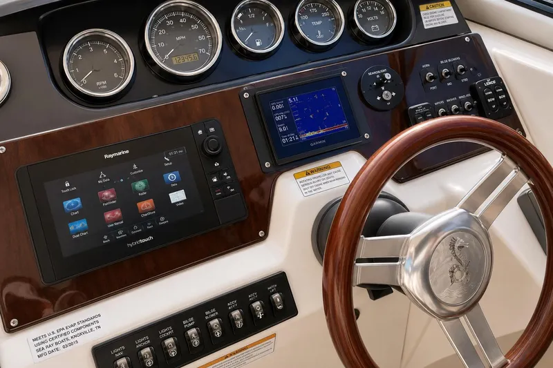 Slide: The Image of Dashboard of 2012 Sea Ray Sundancer 310 with navigation and control instruments. - 11