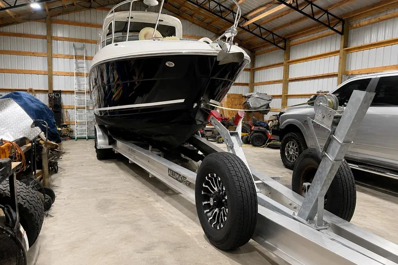 Slide: The Image of 2012 Sea Ray Sundancer 310 on trailer in a storage facility. - 12