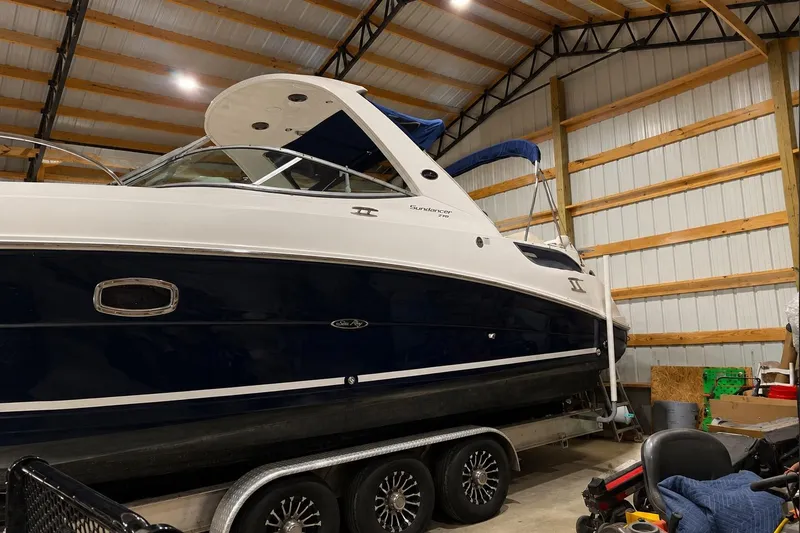 Slide: The Image of 2012 Sea Ray Sundancer 310 boat in storage, showcasing sleek design and modern features. - 13