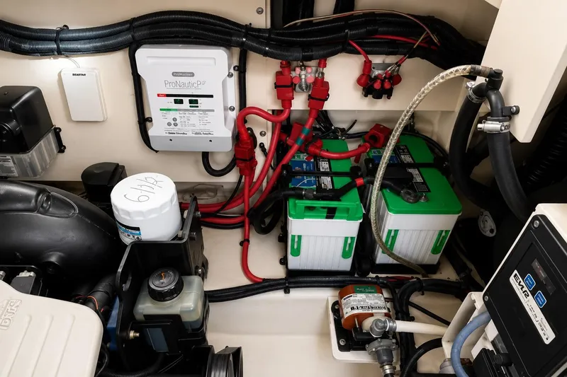 Slide: The Image of Engine compartment of a 2012 Sea Ray Sundancer 310 with batteries and wiring. - 14