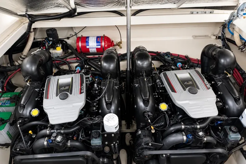 Slide: The Image of Engine compartment of a 2012 Sea Ray Sundancer 310, featuring dual 4.5L engines. - 15