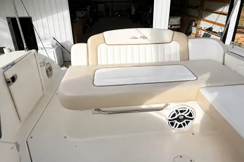 Slide: The Image of 2012 Sea Ray Sundancer 310 boat interior with cushioned seating and speaker. - 2