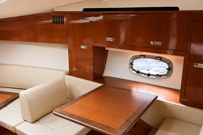 Slide: The Image of Interior of 2012 Sea Ray Sundancer 310 yacht with wood cabinetry and seating area. - 4